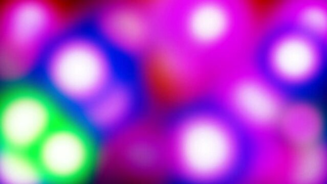 Abstract flickering lights of different colors. Stock 4k video of holiday illumination. The effect of superimposing glowing blurred circles.