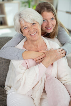 charming blonde lady hugging her mother