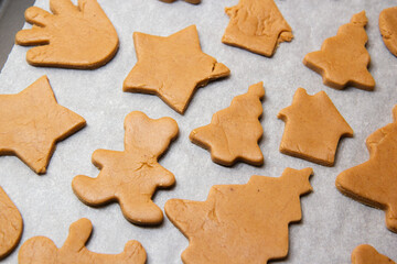 christmas gingerbread on a white parchment on a baking sheet