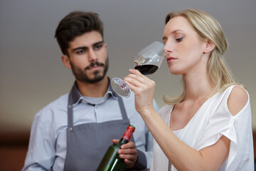 woman trys how it smells in a glasses