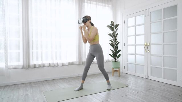 Caucasian woman enjoy playing virtual reality games, Healthy young woman wearing VR glasses exercising.