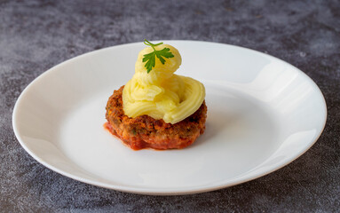 Turkish Food Hasanpasa Kofte - Kofta with Puree - Meatball with Bechamel Sauce and Green Peas. Traditional Food.