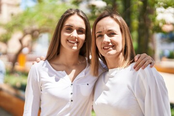 Fototapeta premium Two women mother and daughter hugging each other at park