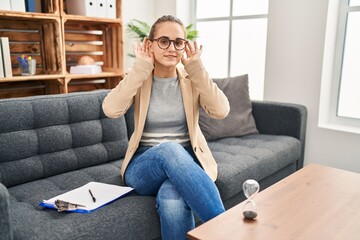 Young woman working at consultation office trying to hear both hands on ear gesture, curious for gossip. hearing problem, deaf