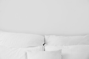 Fototapeta na wymiar Soft pillows on comfortable bed, closeup