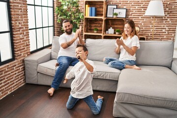Fototapeta premium Family singing song using microphone at home