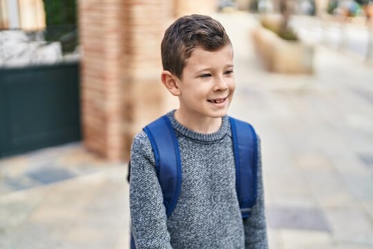 Blond child student smiling confident standing at street