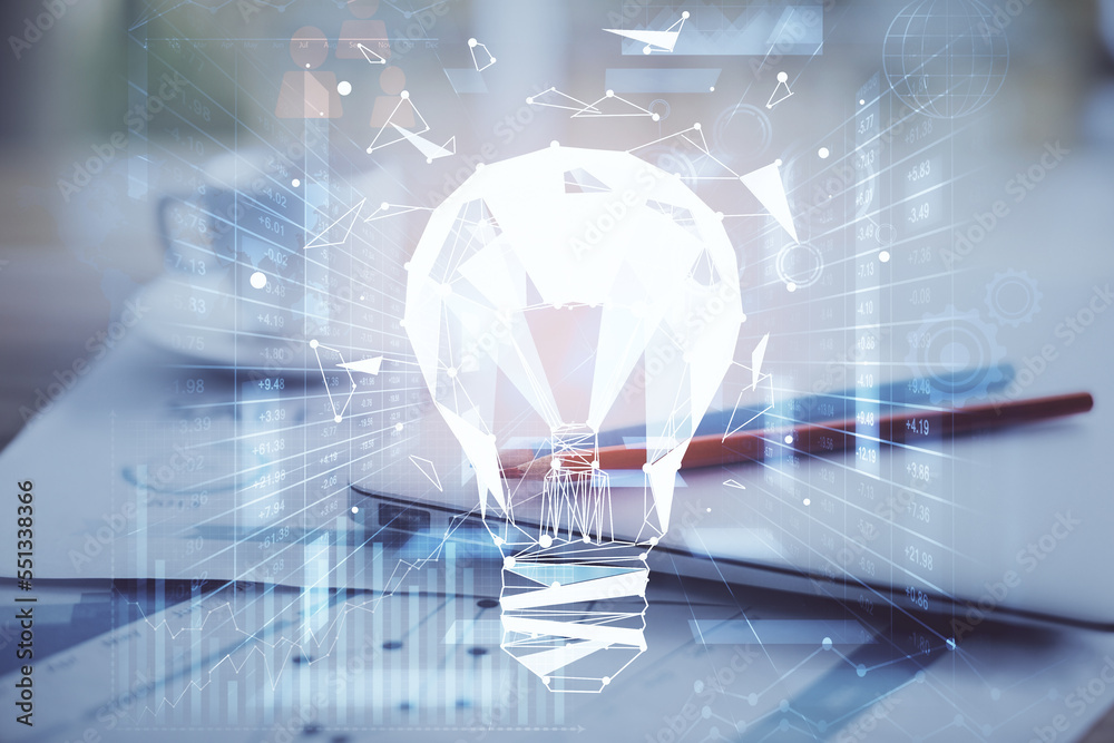 Poster Computer on desktop in office with bulb icon hologram. Double exposure. Concept of idea.