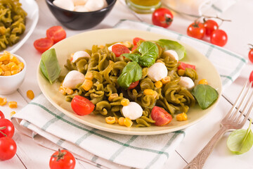 Fusilli pasta with cherry tomatoes and sweet corn.