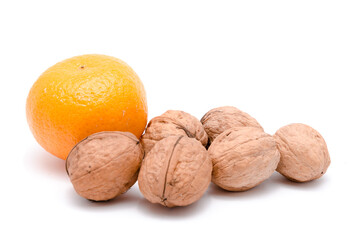 Walnuts and mandarin orange or mandarine, Citrus reticulata, isolated on white background
