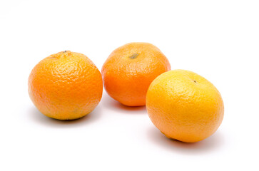 Three mandarin oranges or mandarines, Citrus reticulata, isolated on white background