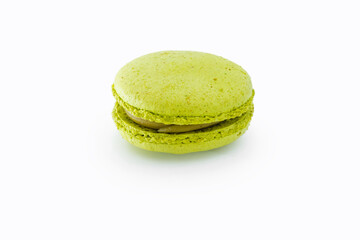 Green French macaroon isolated on white background. Tasty colorful macaroons. French pastry made from egg whites. Culinary and cooking concept.