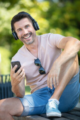 smiling man holding mobile phone
