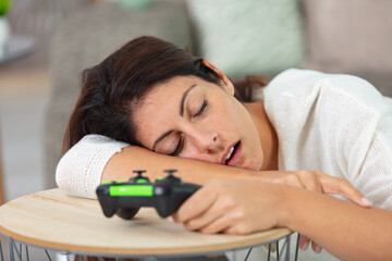 beautiful woman felt asleep playing a video game
