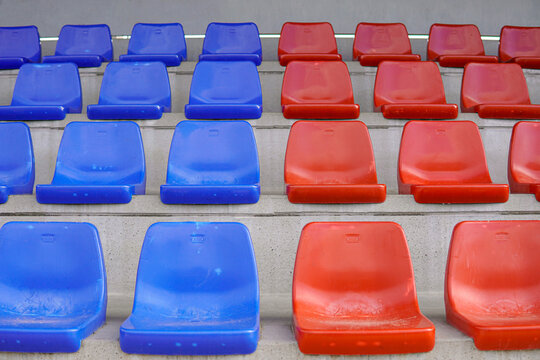 Symmetry tier of empty blue and red seats on a soccer field. Seats in the colors of Bar&ccedil;a in horizontal.