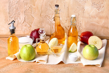 Composition with bottles of apple cider vinegar, fruits, salt and sugar on color background