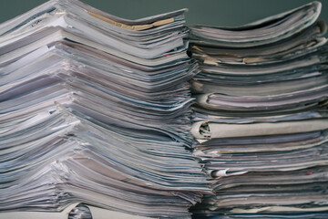 Stack of blank papers with binder clips on wooden table indoors. Workplace. Many documents, contracts, legal agreements, papers on work table. Concept of business, working, job.