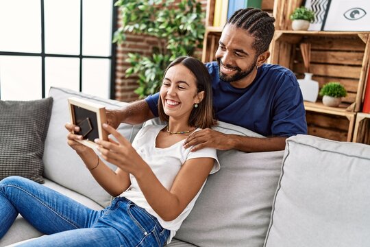 Man and woman couple smiling confident looking photo at home