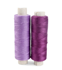 Colorful sewing thread spools on white background
