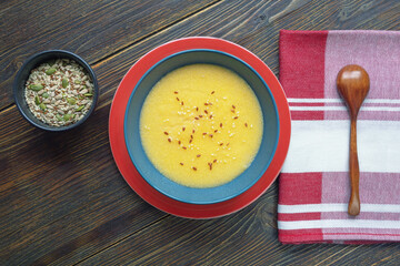 Breakfast. Cornmeal porridge and different seeds in  bowls on rustic table . Flat lay, copy space