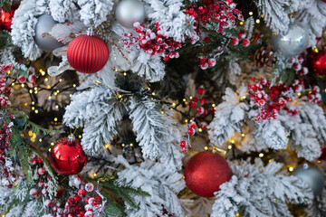 Branches of an artificial Christmas tree with red balls