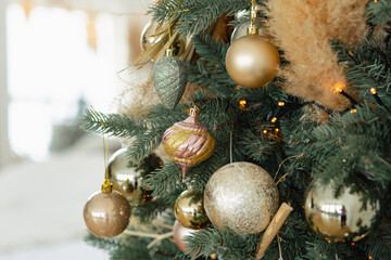 Branches of an artificial Christmas tree with gold balls