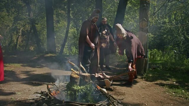 mystical fraternal rite on the blood of two warriors. the priestess and the shaman supervise the execution process.