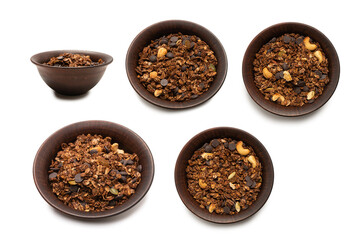 Chocolate granola cereal with nuts in a bowl background.