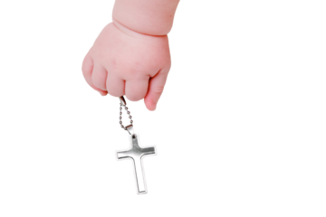 Baby hand and christian religious symbol of the cross, close-up, isolated on a white background. Children fingers and an object on a white background