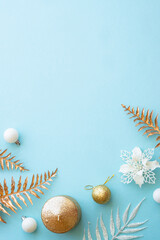 Christmas composition with white and golden holiday decorations on blue. Flat lay image with copy space.