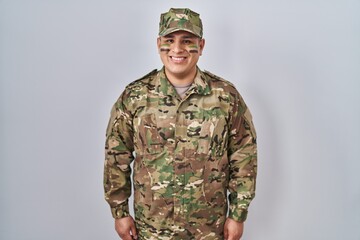 Hispanic young man wearing camouflage army uniform with a happy and cool smile on face. lucky person.