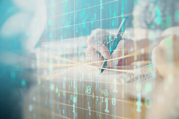 Double exposure of hands making notes background with technology and digital coding huds. Data...