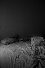 unmade bed in black and white