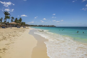 View of Eagle beach in Atlantic ocean with white sands on sunny day. Aruba.