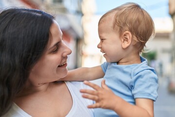 Mother and son smiling confident standing at street