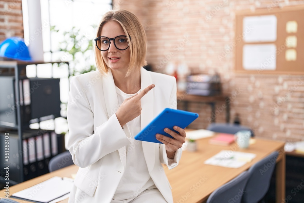 Sticker young caucasian woman working at the office wearing glasses pointing aside worried and nervous with 