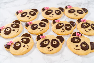 Panda shaped shortbread cookies with chocolate icing