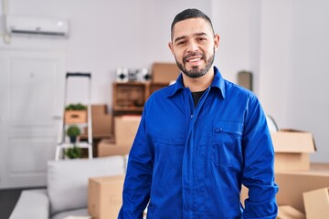 Young latin man worker smiling confident standing at new home - obrazy, fototapety, plakaty