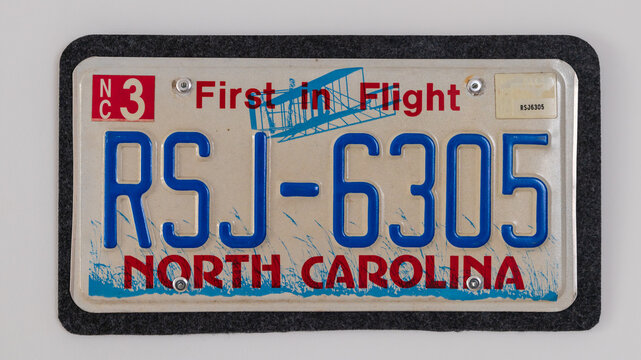 Art on an unregister car licence plate from First in World Flight State North Carolina in United States of America. Isolated on white background.