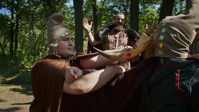 mystical fraternal rite on the blood of two warriors. the priestess and the shaman supervise the execution process.