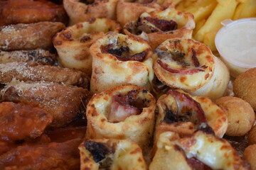 Fast food mix, pizza rolls, cheese meatballs, fries, chicken wings