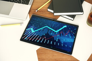 Modern digital tablet screen with abstract financial graph and upward arrow, financial and trading concept. Top view. 3D Rendering