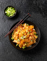Spicy bamboo shoot salad in black bowl. Asian food