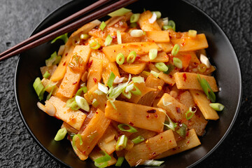 Spicy bamboo shoot salad in black bowl. Asian food