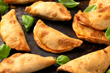 Freshly baked mini calzones pizza filled with bolognese