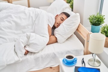 Young hispanic man lying on bed sleeping at bedroom