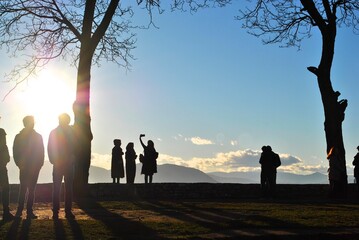 group of people taking pictures in park 