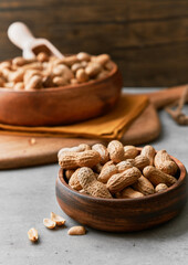 Image of bunch of peanuts in a bowl on a concrete surface