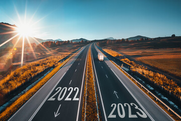 2023 Happy New Year text on the road, concept for trip travel and future vision for successful start straight, planning and challenge or career path,business strategy,opportunity and change, new goals
