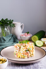 Olivier salad on a plate ingredients for its preparation on the table. Christmas snacks. Vertical